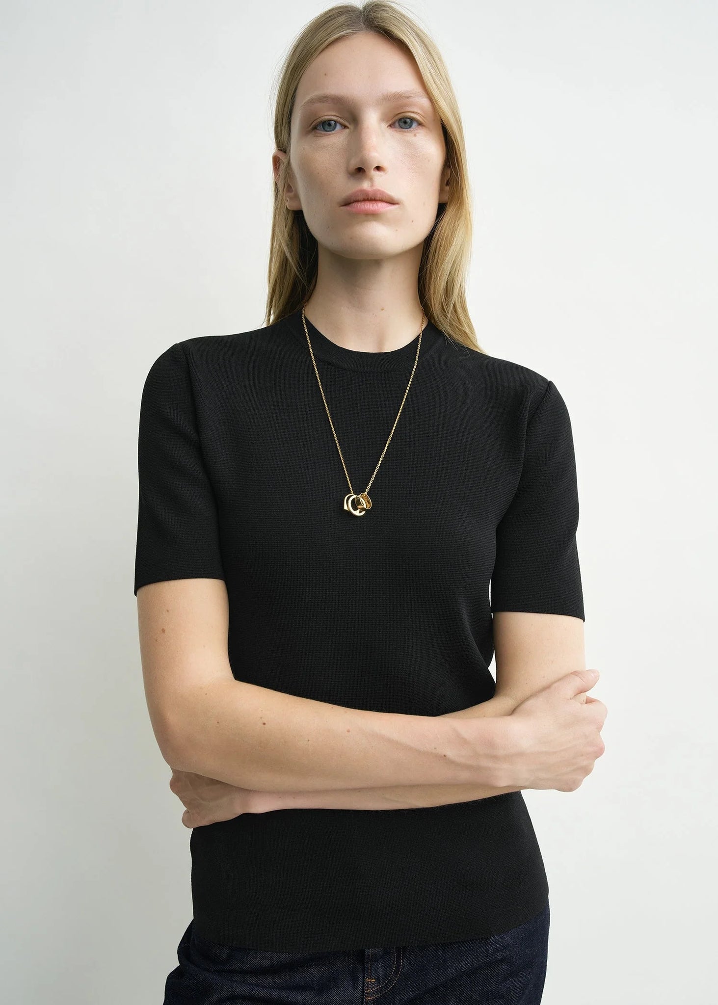 Model wearing the Compact Knit Top in Black by TOTEME, perfect for casual or stylish outfits.