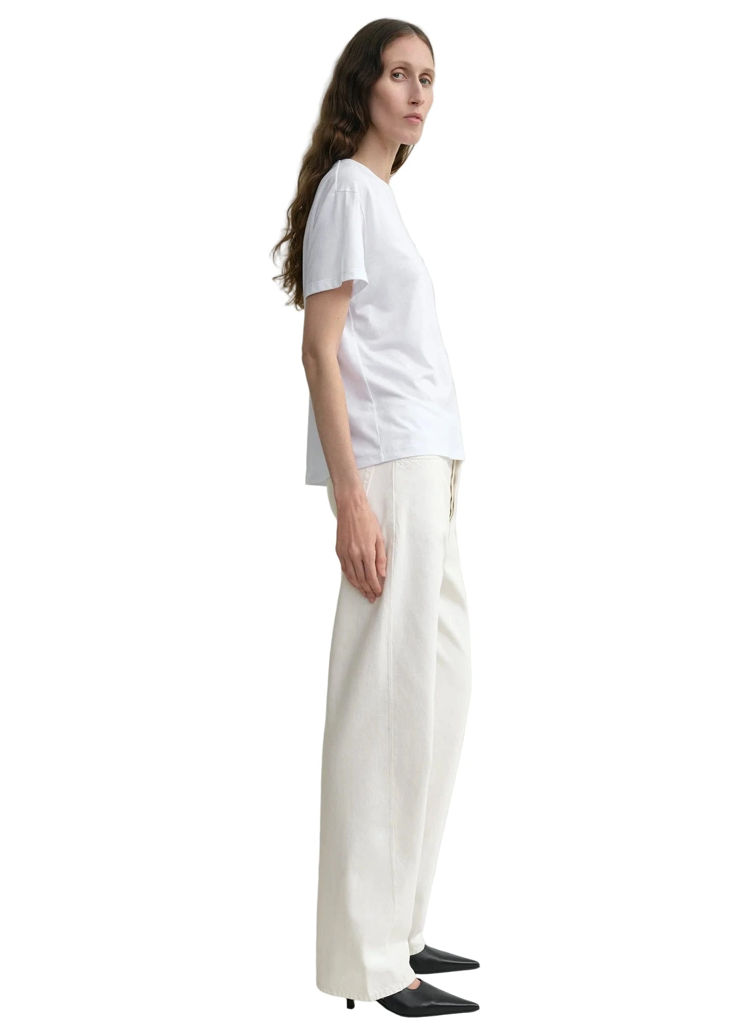 The Twisted Seam Full Length Jean in Off-white laid flat, emphasizing its unique twisted seam design and clean lines.