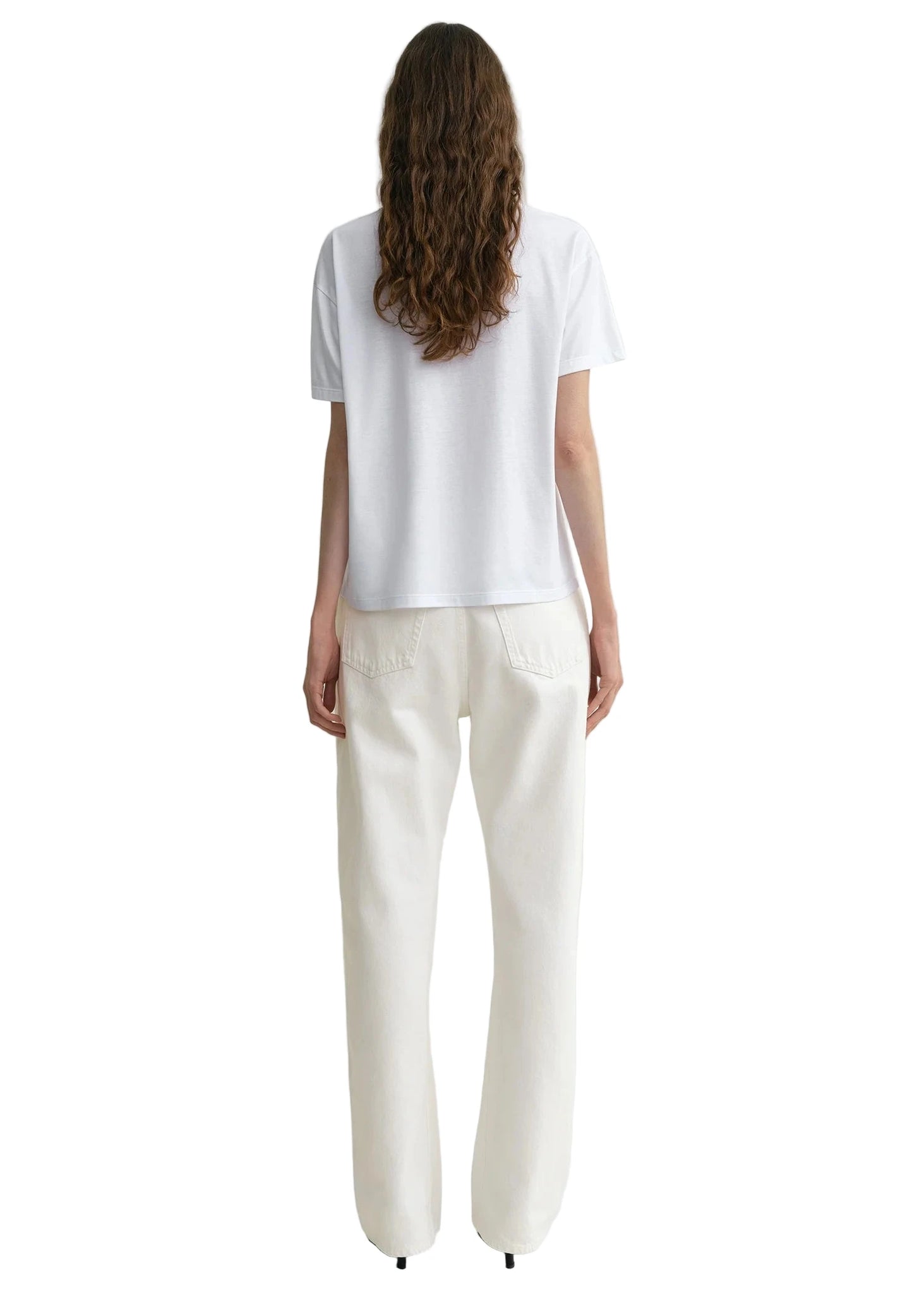 Back view of the Twisted Seam Full Length Jean in Off-white, illustrating how it fits and the style's modern look.