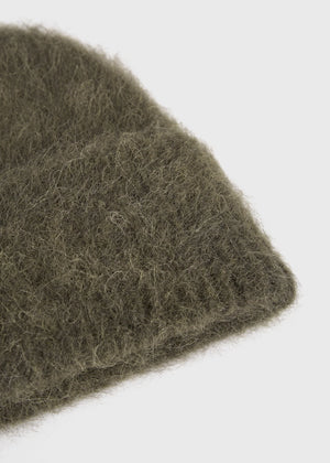 Flat lay of the Alpaca Knit Beanie in Pepper from TOTEME, perfect for winter styling.