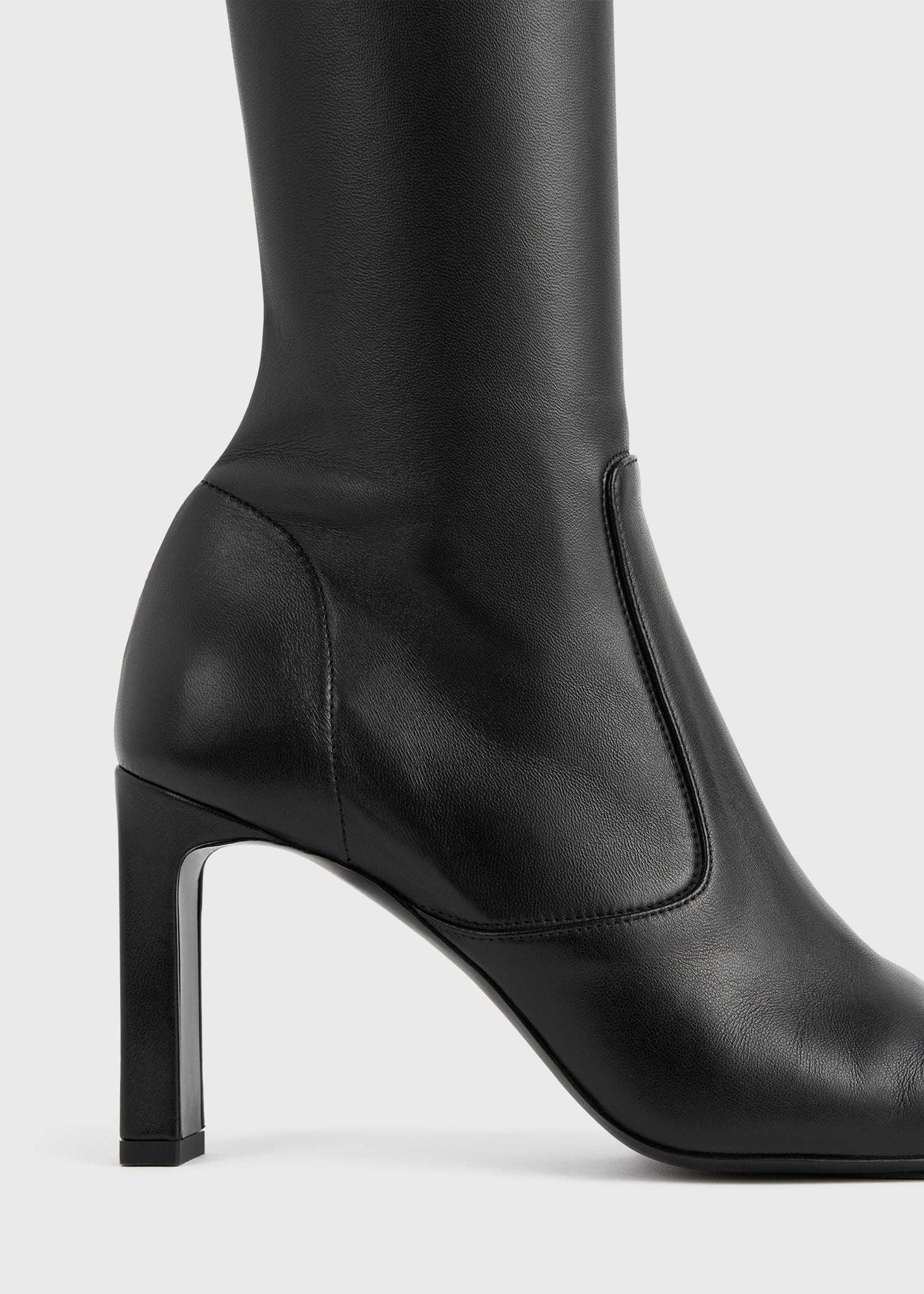 Chic Over-the-knee Boot in Black designed by TOTEME, perfect for pairing with dresses and skirts.