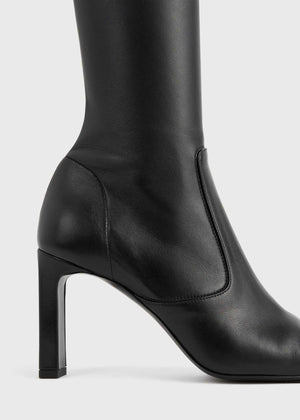 Chic Over-the-knee Boot in Black designed by TOTEME, perfect for pairing with dresses and skirts.