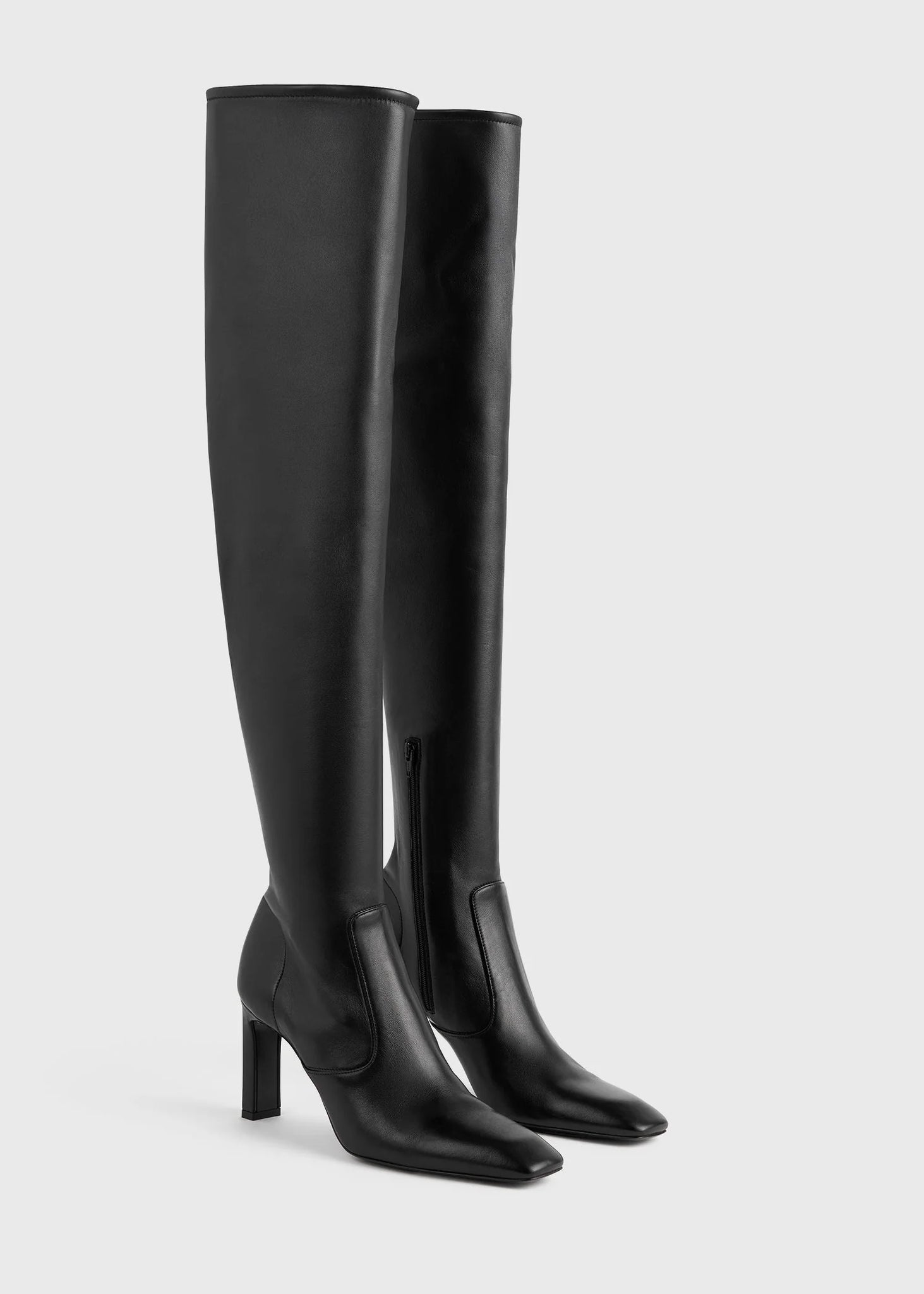 Stylish Over-the-knee Boot in Black from TOTEME, featuring a bar-shaped heel and zipper detail.