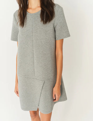 Stylish model wearing the Nice Mini Dress in Grey Melange paired with heels for an elevated look by THE GARMENT.