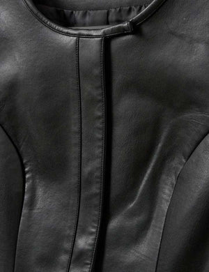 The Brooklyn Mini Dress in Black displayed on a hanger emphasizing its chic style.