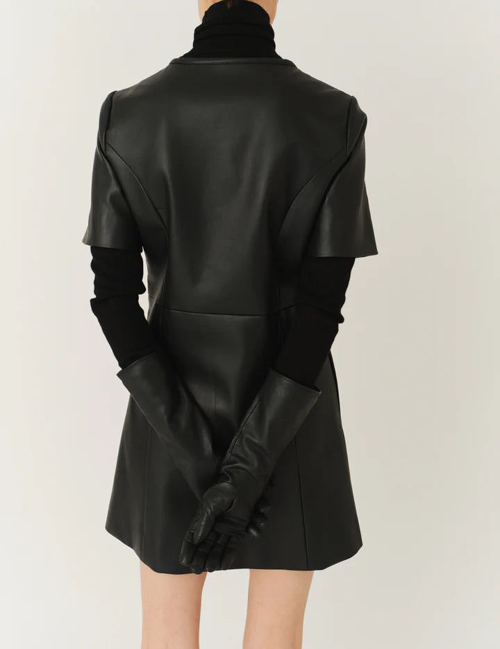 Close-up of the Brooklyn Mini Dress in Black focusing on the leather-like material.