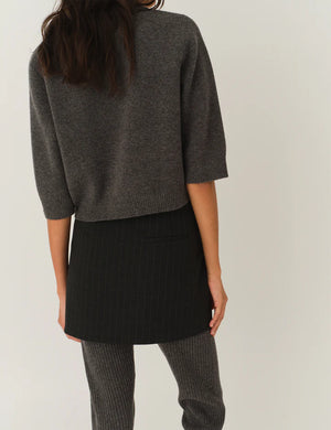 Back view of the Como Short Cardigan in Grey Melange, emphasizing its sophisticated cut and button details.