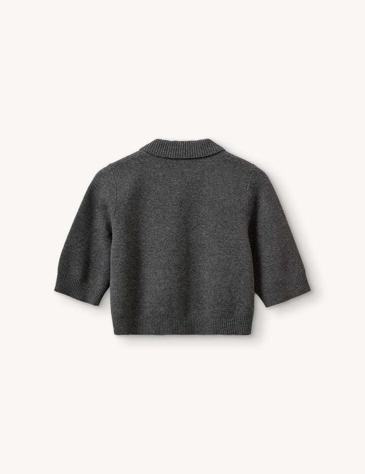 Como Short Cardigan in Grey Melange folded neatly, showing off its chic and comfortable design ideal for any wardrobe.