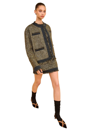 Side angle of the Ulla Johnson Carmella Tweed Coat in Tapestry highlighting the tailored fit and lustrous taffeta trims.