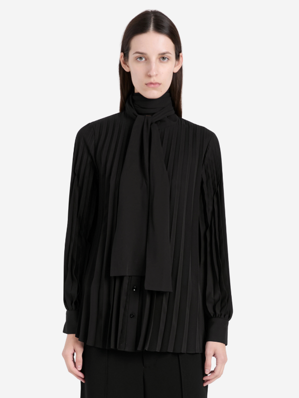 Back view of the Soomin Top in Black, highlighting the flowy design and pleated fabric.