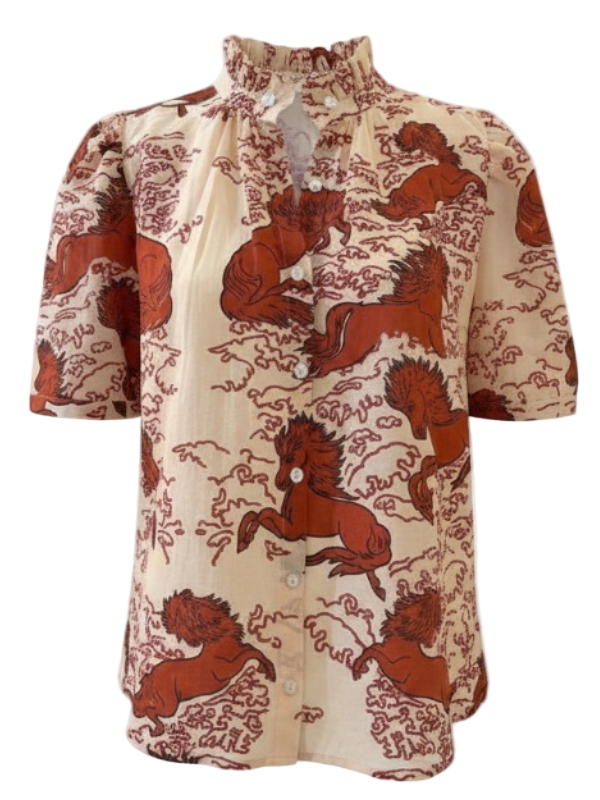 Winnie Rouge Pegasus Shirt in Off-White featuring a unique hand-block printed design with vintage-inspired illustrations of horses and waves, crafted from lightweight cotton-silk voile. This luxury shirt by Alix of Bohemia boasts short puffed sleeves and a ruffled collar, showcasing artisanal craftsmanship with subtle variations.