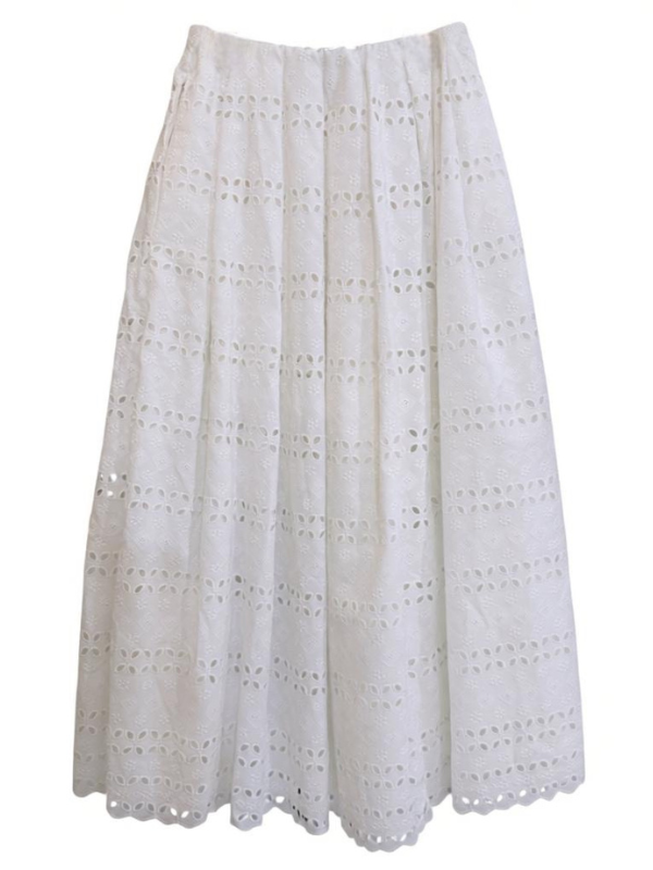Elegant Abajo Skirt in Rosa Broderie White by Faithfull, featuring a pleated design with scalloped hem, crafted from a luxurious cotton blend.