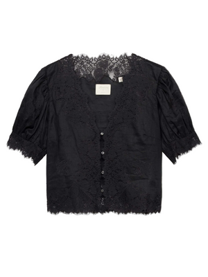 Dôen Idella Top in Black featuring a plunging V-neckline and short puffed sleeves against a soft backdrop.