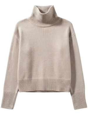 Fleur Sweater in Sand featuring a luxurious ribbed-knit cashmere fabric, showcasing a boxy silhouette and a loose turtleneck, ideal for elegant layering.