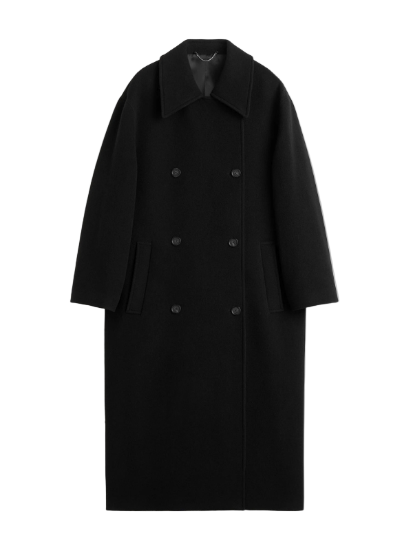 Shield Coat in Black by TOTEME, featuring a long oversized silhouette and double-breasted front.