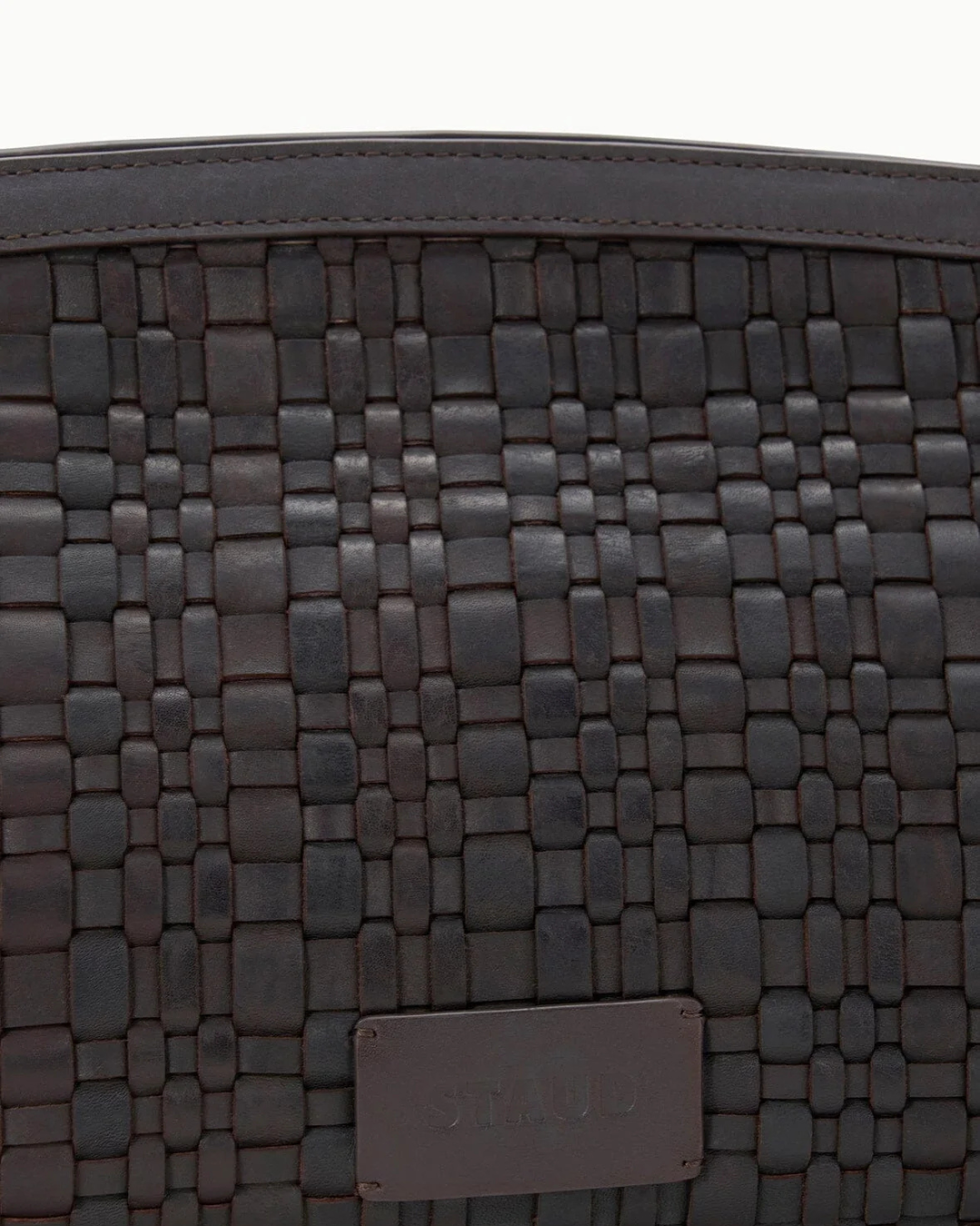 Chic Maude Soft Clutch in Espresso Woven, a signature woven leather clutch by STAUD with a magnetic closure.