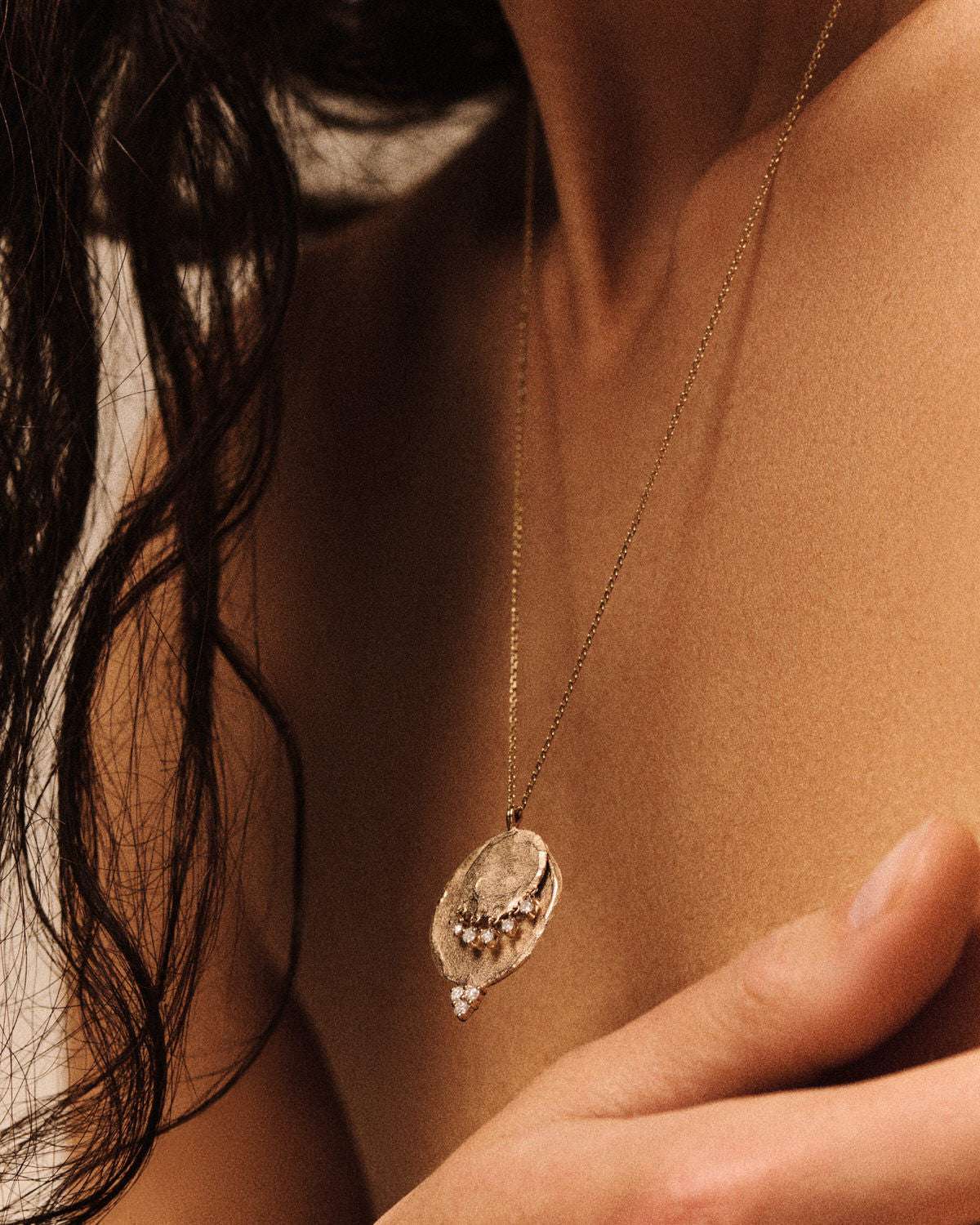 Elegant Gaby No2 Necklace in Gold draped on a soft surface, highlighting the intricate design by Pascale Monvoisin.