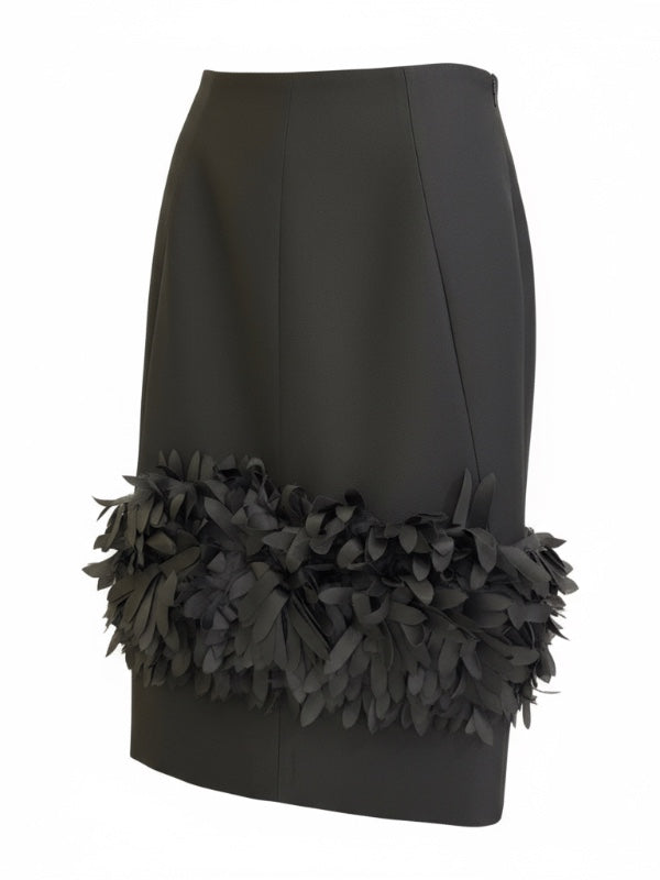 Close-up of the Petal Skirt in Black from TOTEME, highlighting the back zipper and kick pleat detail.