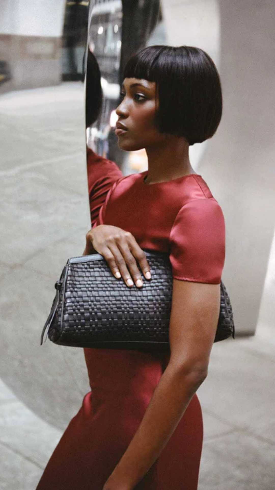Model holding handbag from Staud as a clutch