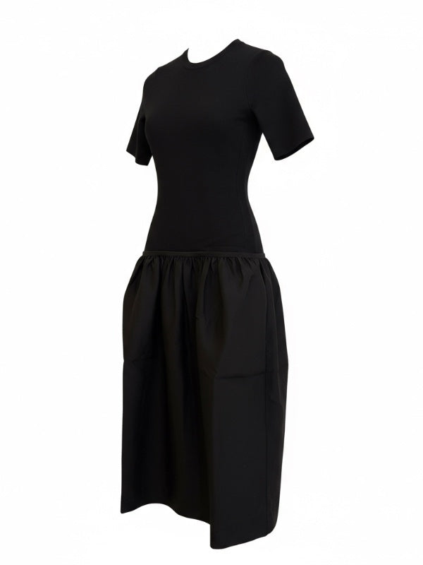 Elegant view of the Twinflowers Tee Dress in Black showcasing its luxurious fabric composition and design details.