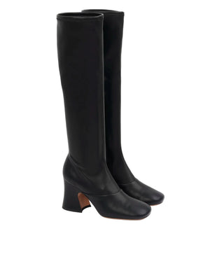 Side view of Chloé Janis Heeled Boots in Black highlighting the stacked flared heel and elegant high tube leg.
