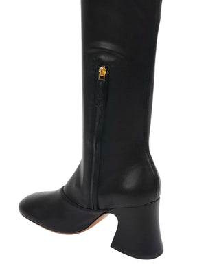 Chloé Janis Heeled Boots in Black worn in a chic outfit, emphasizing their stylish appeal and versatility.