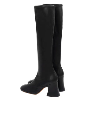 Close-up of the texture on Chloé Janis Heeled Boots in Black revealing the soft leather-effect stretch material.