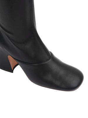 Back view of Chloé Janis Heeled Boots in Black displaying the unique heel design and luxurious lambskin lining.