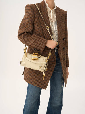 Close-up of the Small Paddington Chain Bag in Cloudy Cream featuring oversized padlock detail.