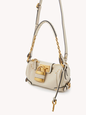 Side view of the Small Paddington Chain Bag in Cloudy Cream highlighting the sleek silhouette.
