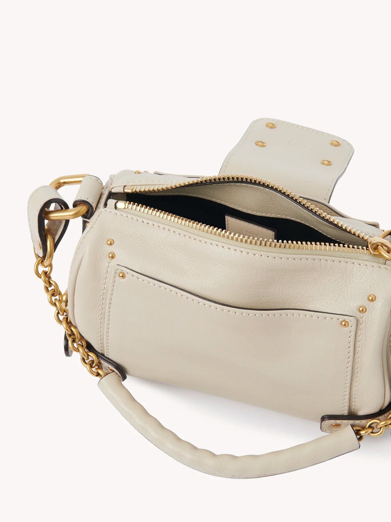 Small Paddington Chain Bag in Cloudy Cream open to show the cotton lining.
