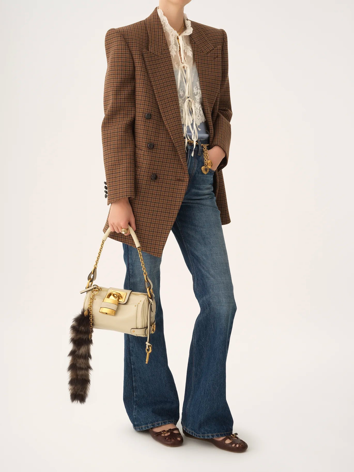 Back view of the Small Paddington Chain Bag in Cloudy Cream illustrating the C-shaped buckles.