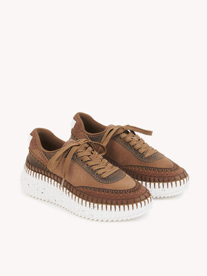 Close-up detail of the Chloé Nama Sneakers in Oak Brown highlighting the hand-finished blanket stitching.