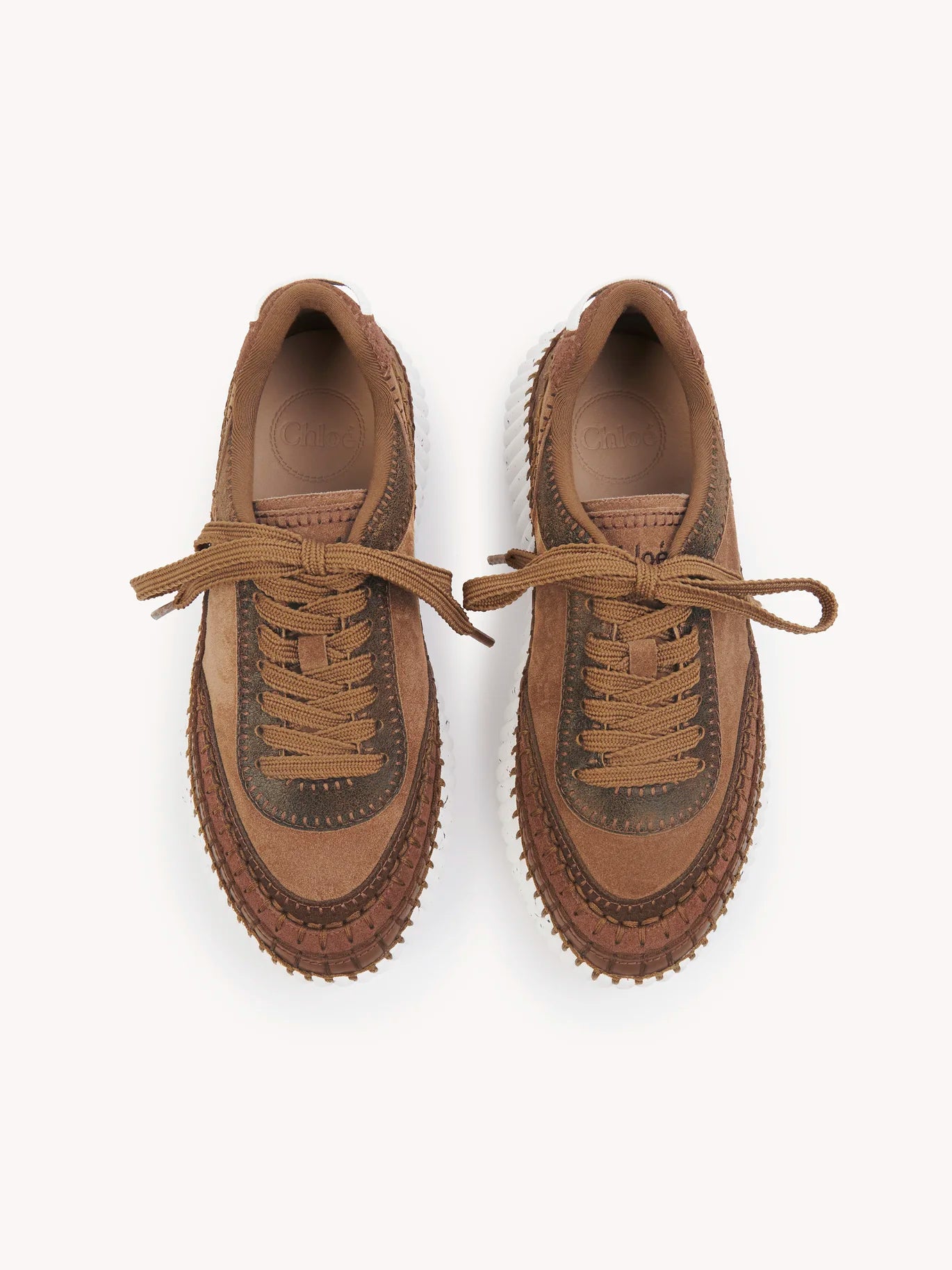 Chloé Nama Sneakers in Oak Brown displayed with the logo embroidery on the tongue and back.