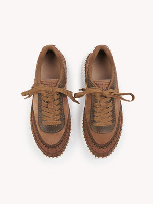 Chloé Nama Sneakers in Oak Brown displayed with the logo embroidery on the tongue and back.
