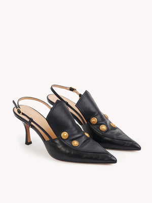Close-up of Chloé's Agnes Slingback in Black, featuring gold-tone buttons and an adjustable ankle strap.